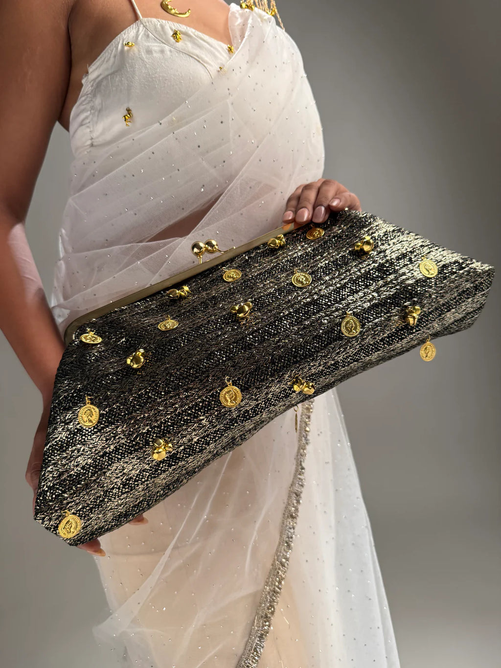 Black and gold kiss-clip oversized clutch with coin charms”

“Handcrafted black evening bag with gold detailing by Clutch It”

“Noir Royale oversized metallic clutch for weddings and events