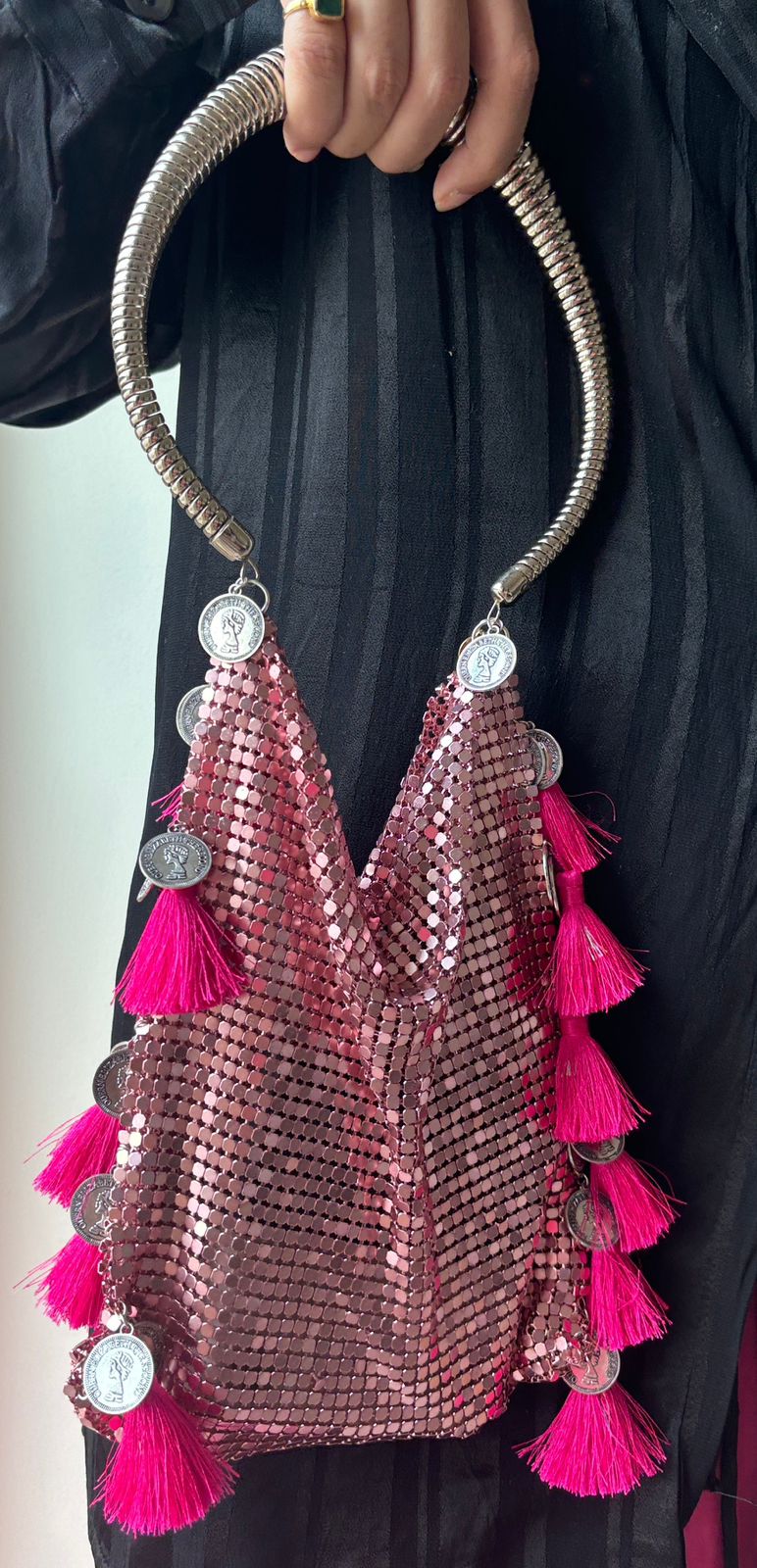 Pink mesh party bag with fuchsia tassels and silver coin charms
